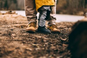 Schuhe und Beine von Erwachsenem und Kind
