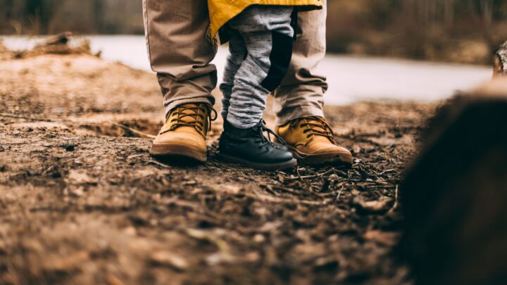 Schuhe und Beine von Erwachsenem und Kind